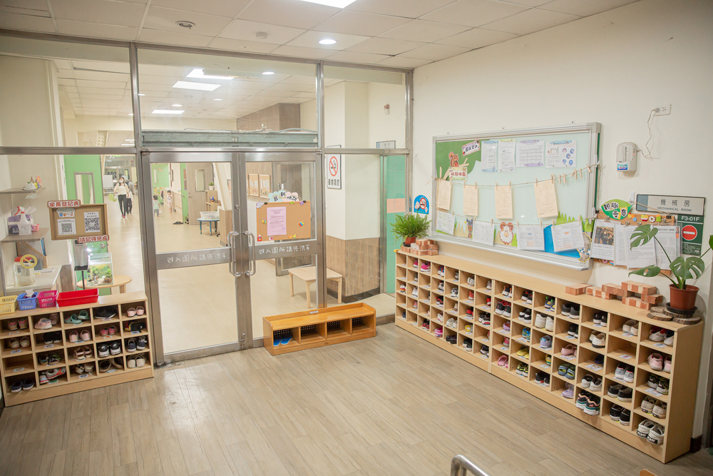 幼兒園前門放置許多鞋櫃，透過玻璃門可以看到園內的走廊及教室