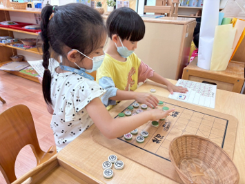 兩位幼兒在學習如何玩象棋